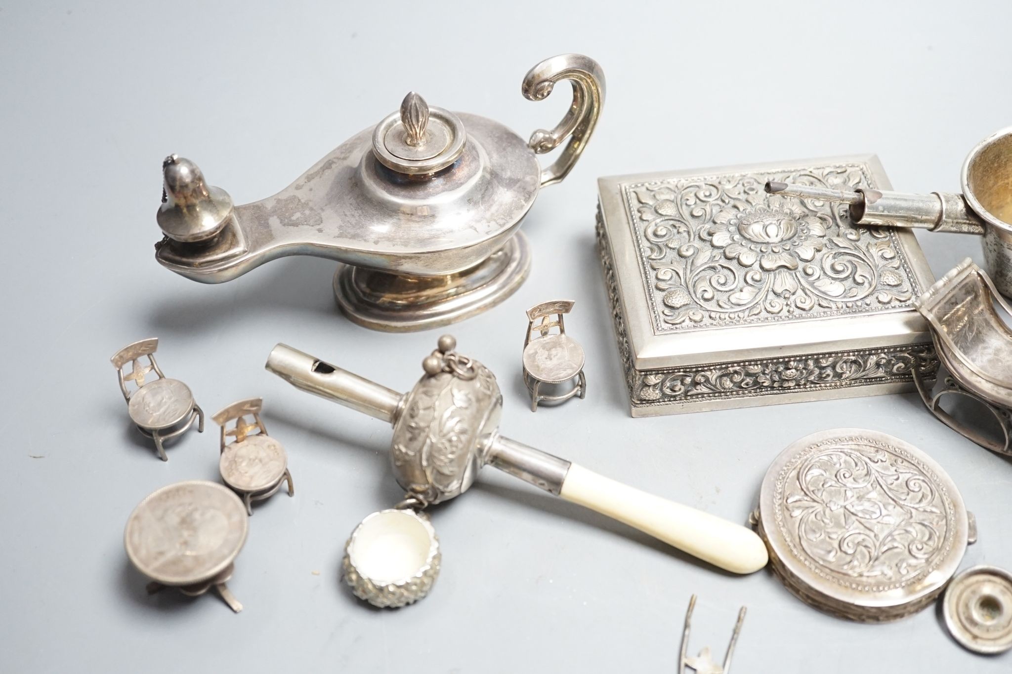 A group of small continental white metal items including a 800 compact, coin mounted miniature furniture, cigarette box, plated lamp lighter, etc.